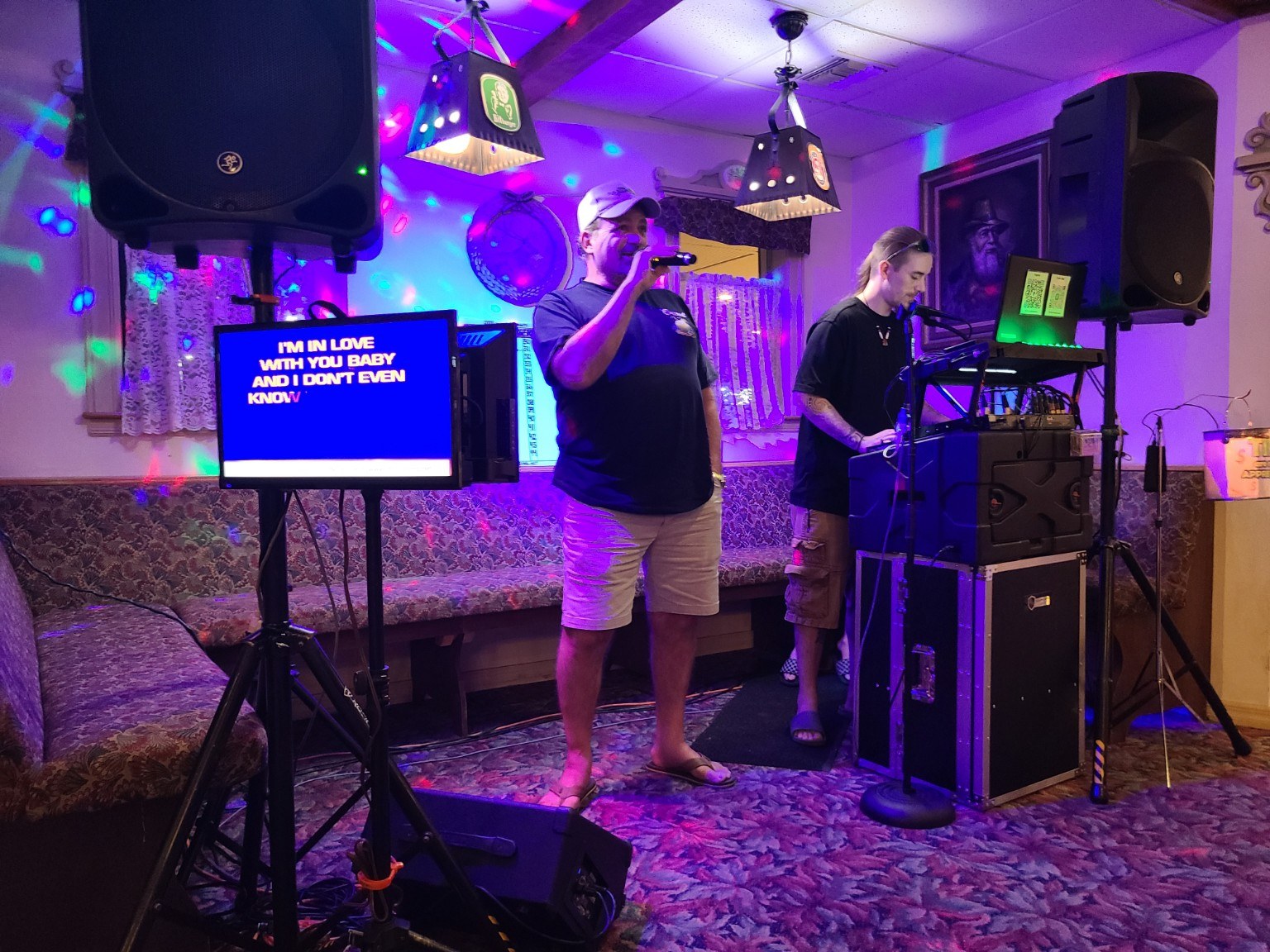 Guest singing karaoke at a lively show